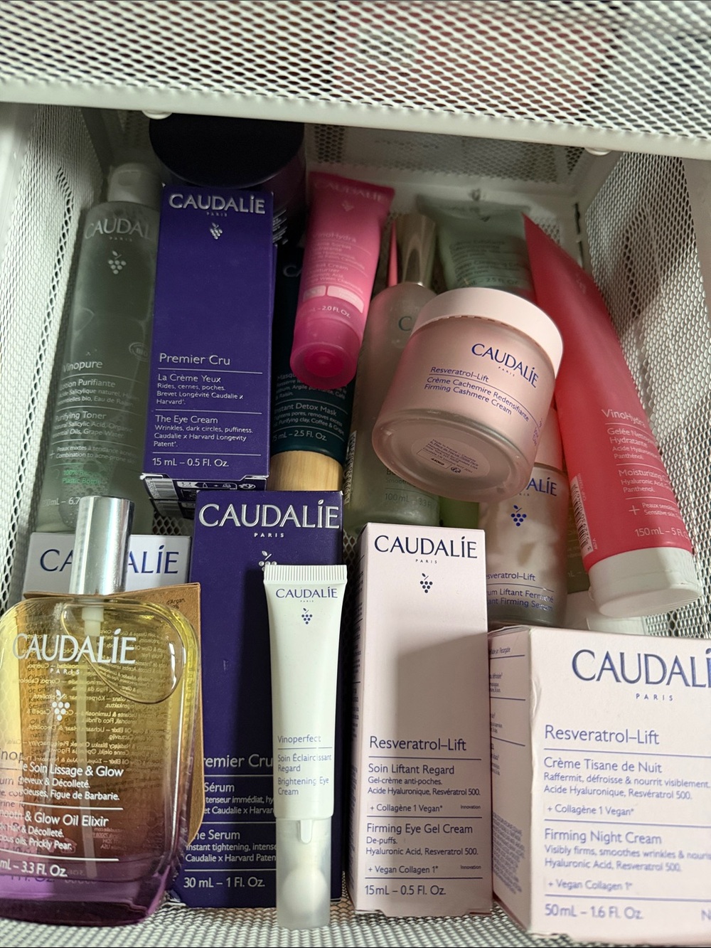 Caudalie skincare set with pink and purple accents